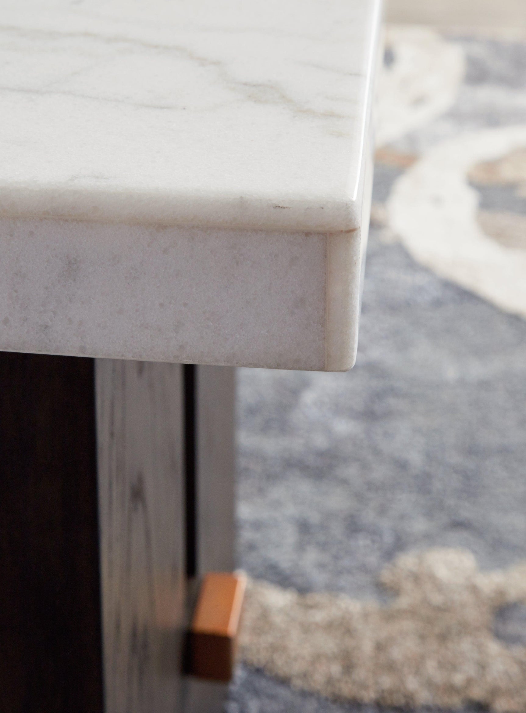 Close-up of dark waxy brown oak finish and marble surface on Burkhaus end table
