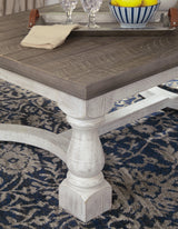 Side angle of Havalance coffee table showing vintage white base and robust legs