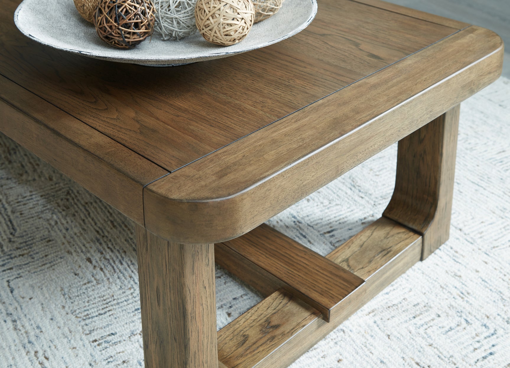 Cabalynn light brown coffee table with two end tables from front angle