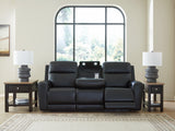 Drop-down table with LED lights and dual cup holders open on sofa