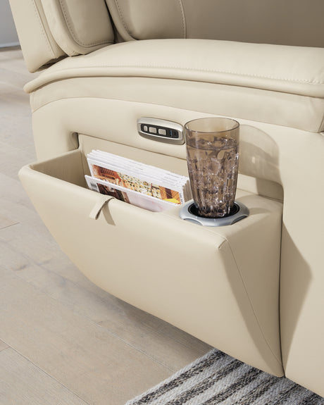 Pop-out storage compartment in armrest detail