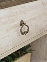 Detail view of Willowton TV stand whitewashed finish