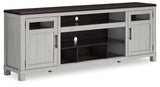 Angled view of Darborn gray and brown TV stand showing cabinet doors