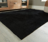 Side angle of Anaben Black 5x7 rug showing pile height