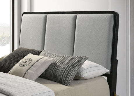 Detail of grey fabric upholstery and foam padding on headboard