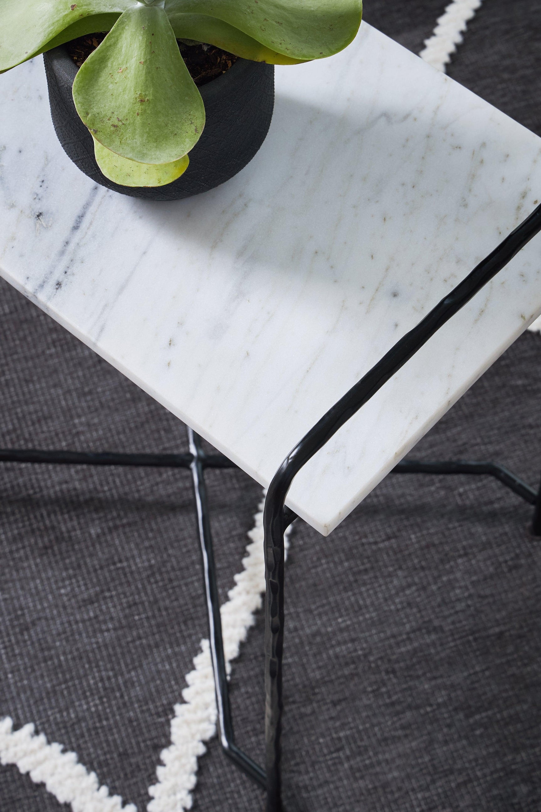 Ashber accent table positioned beside sofa showing size