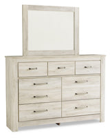 Side view of Bellaby Whitewash Panel Bedroom Set queen bed