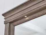 Close-up of round metal knobs with satin nickel-tone finish on dresser