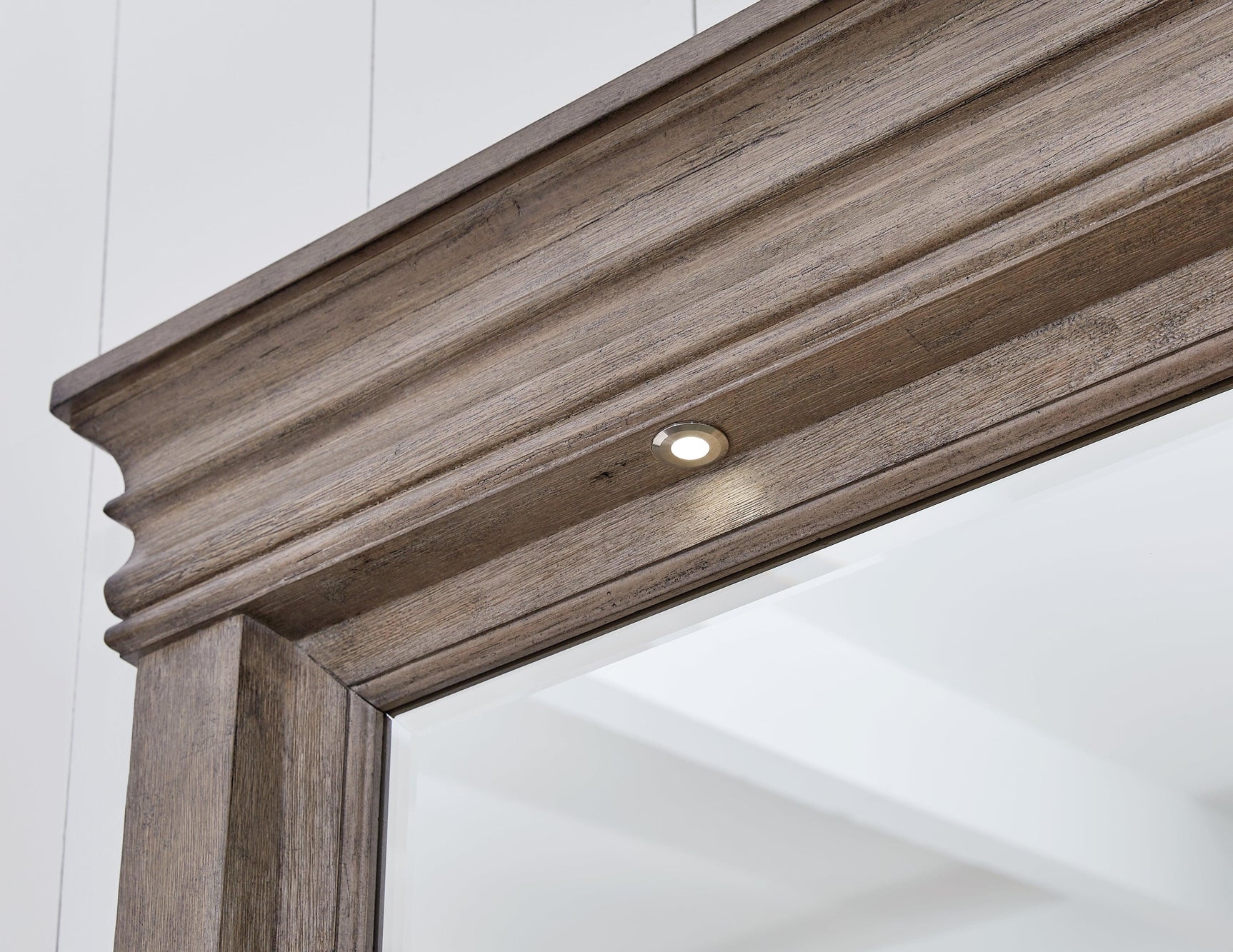 Close-up of round metal knobs with satin nickel-tone finish on dresser
