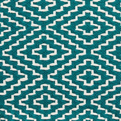 Lifestyle image of Brynnsen teal and ivory pouf in living room