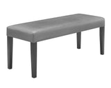 close-up detail of gray faux leather chair and glass tabletop