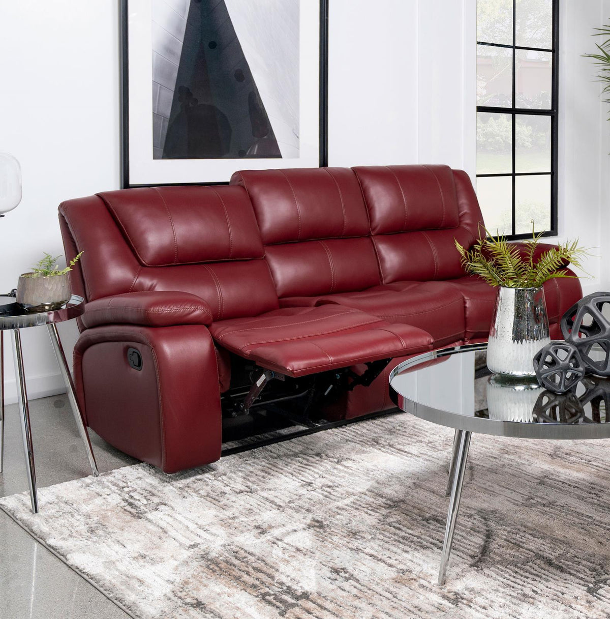 Camila red upholstered motion reclining sofa showing manual recline button