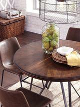 Close-up detail of the metallic base and upholstery on Centiar Dining Room Set