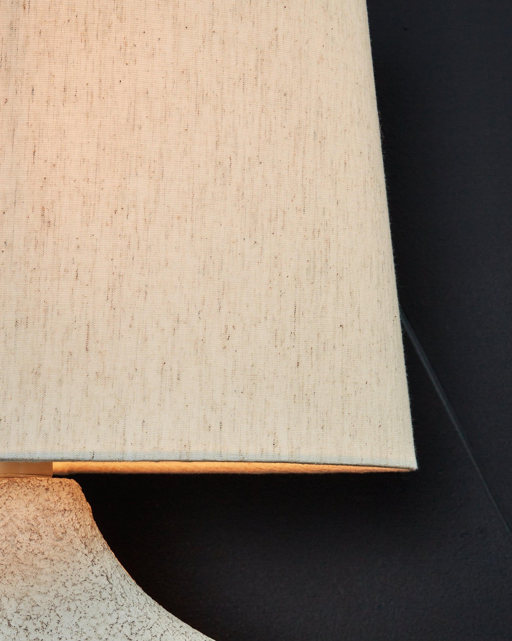 Chadrich table lamp with lit beige fabric shade