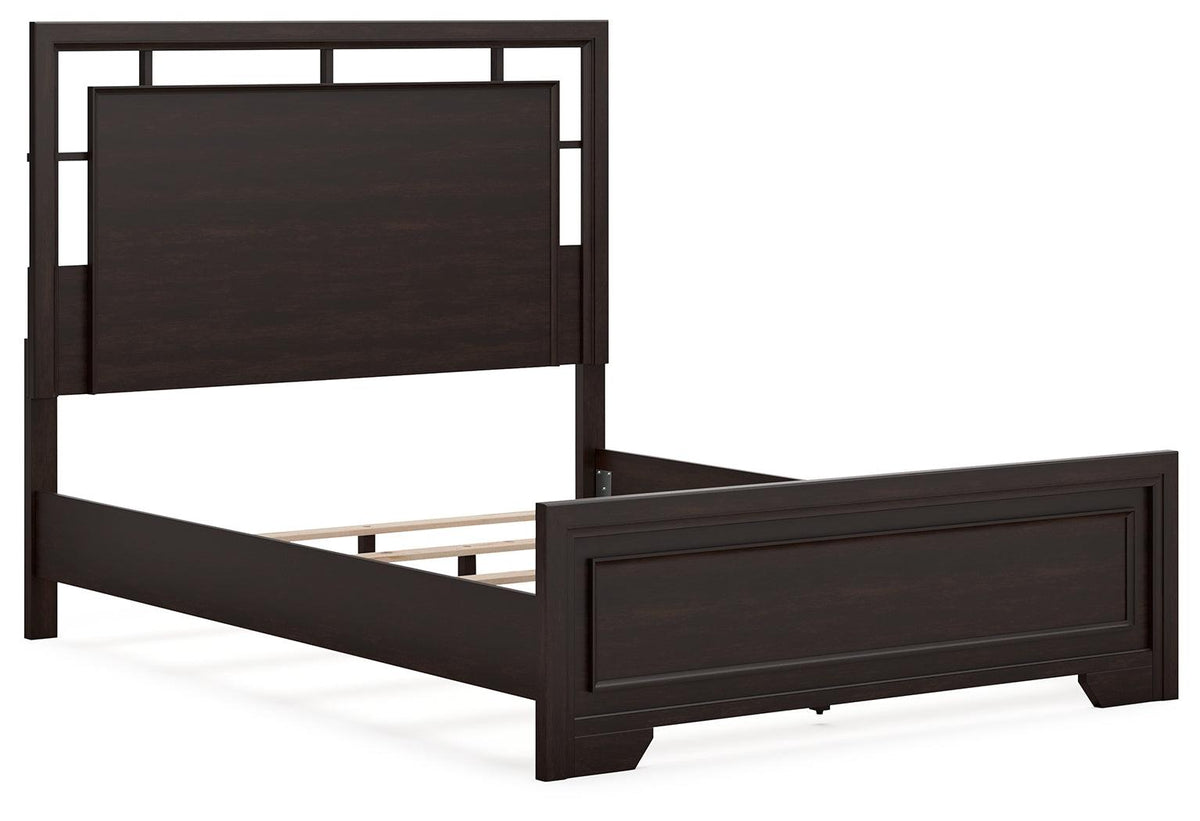 Dark brown queen bed footboard close-up