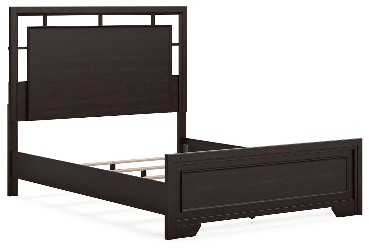Dark brown queen bed footboard close-up