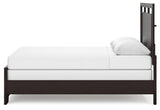 Assembled Covetown queen panel bed in bedroom