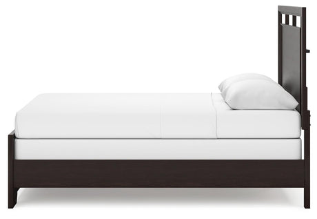 Assembled Covetown queen panel bed in bedroom