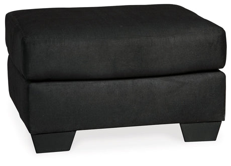 Tapered feet on Darcy ottoman in black faux wood finish
