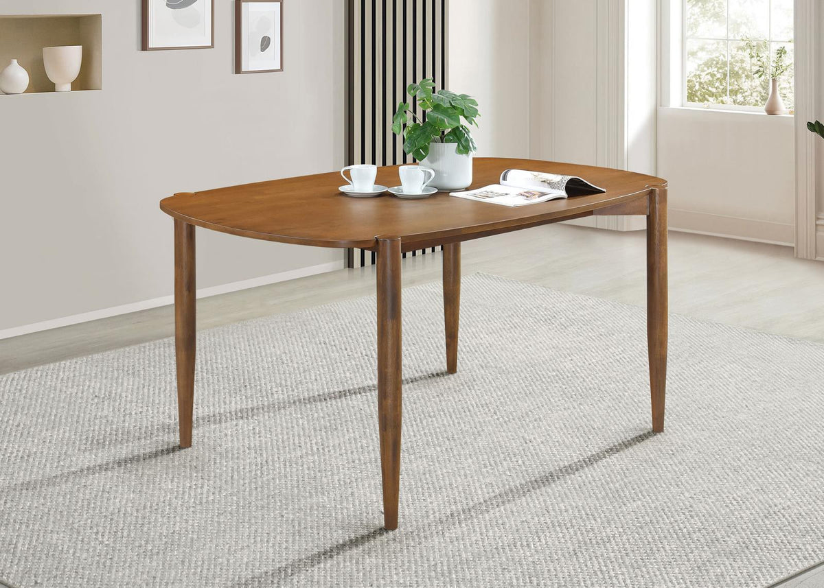 Close-up of walnut finish and tapered leg on Dortch oval dining table