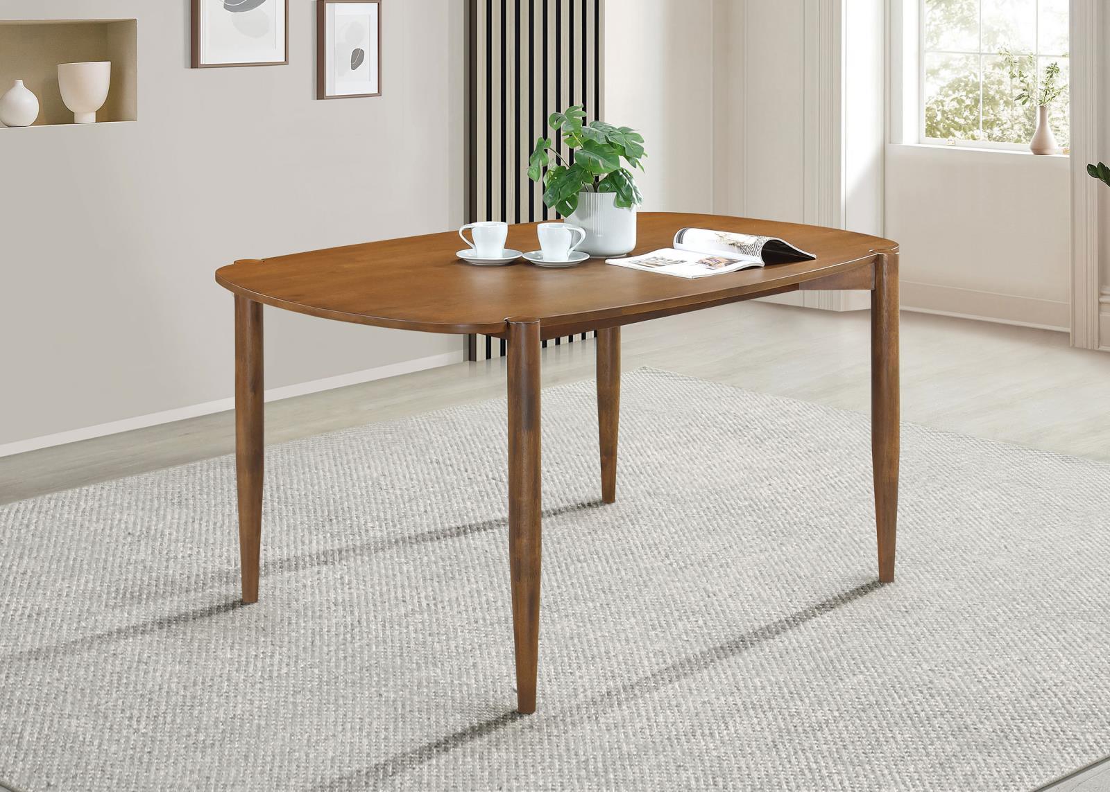 Close-up of walnut finish and tapered leg on Dortch oval dining table