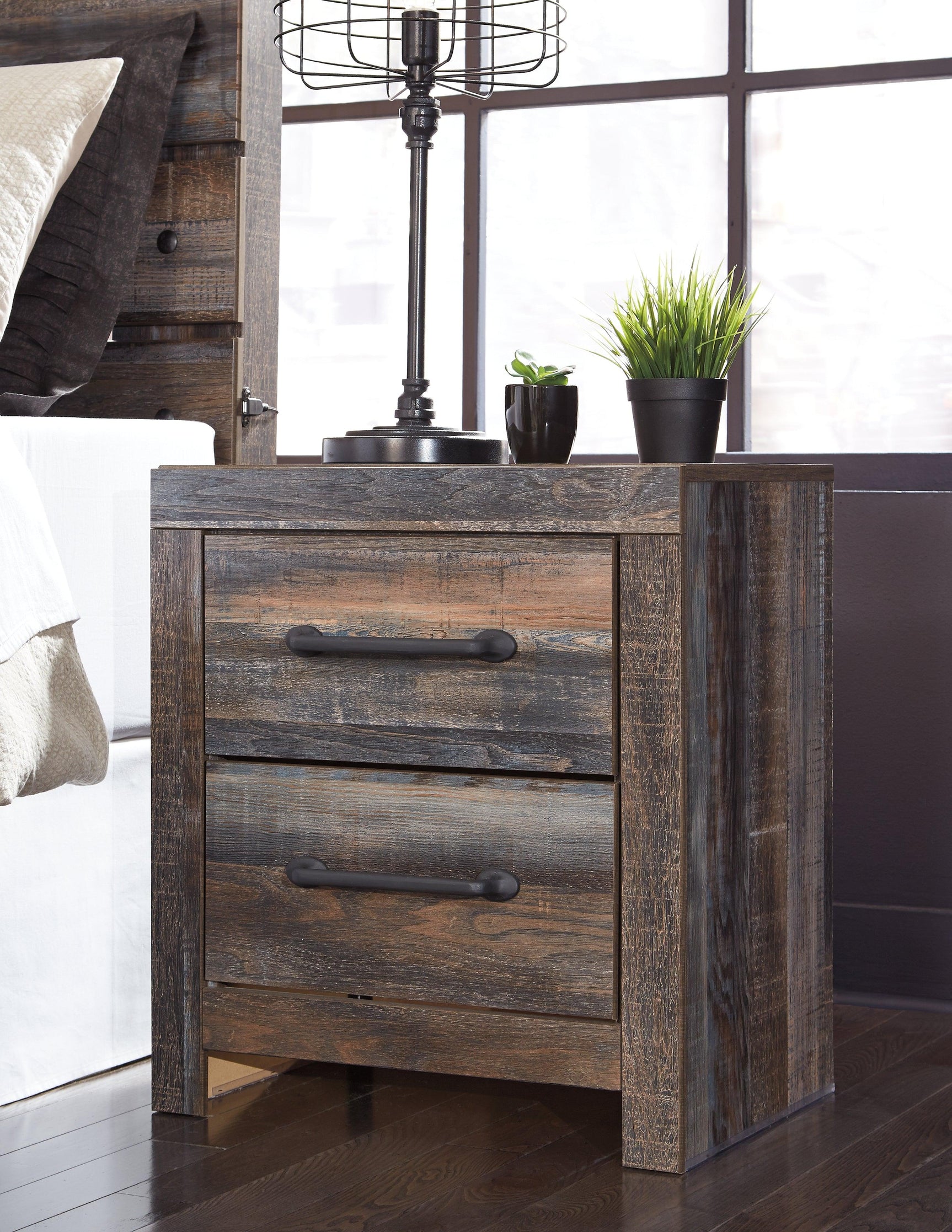 Side perspective showing storage drawers on bed