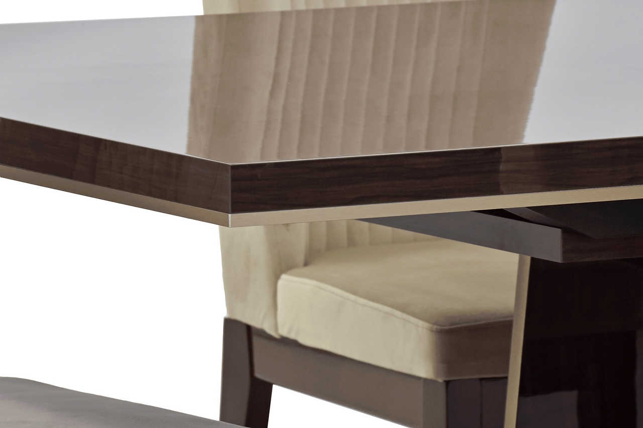 Eva Dining Chair showing soft upholstery and glossy walnut lacquer