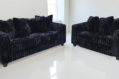 Front angle view of Gia Black 2-Piece Living Room Set showing sofa and loveseat