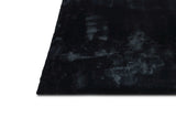 Folded view of Rabbit Black black area rug