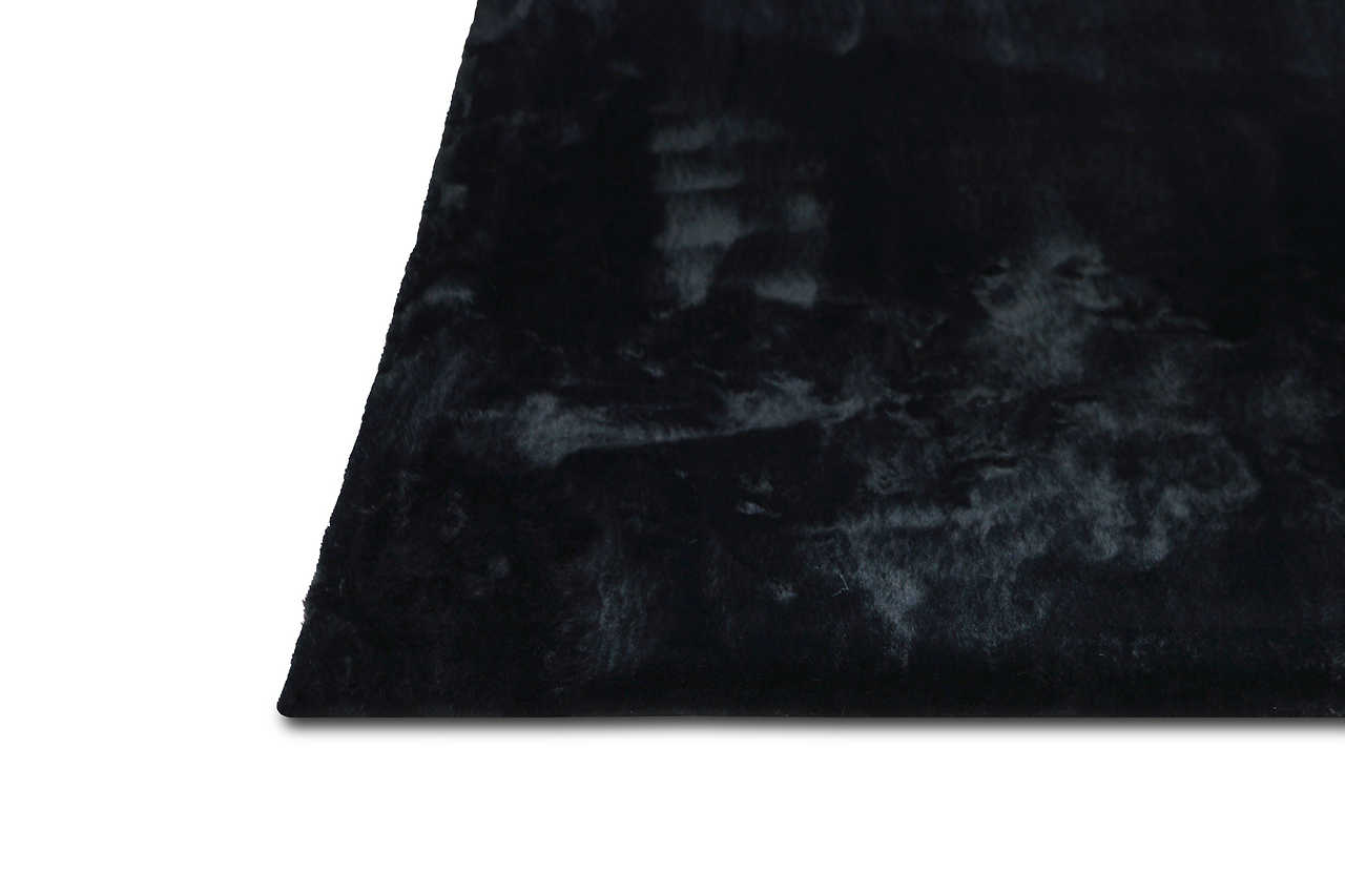 Folded view of Rabbit Black black area rug