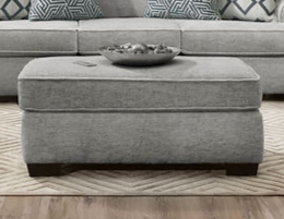 Ritzy grey upholstered ottoman angled view