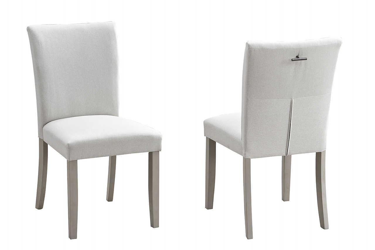 Detail view highlighting the grey fabric upholstery on the dining chairs