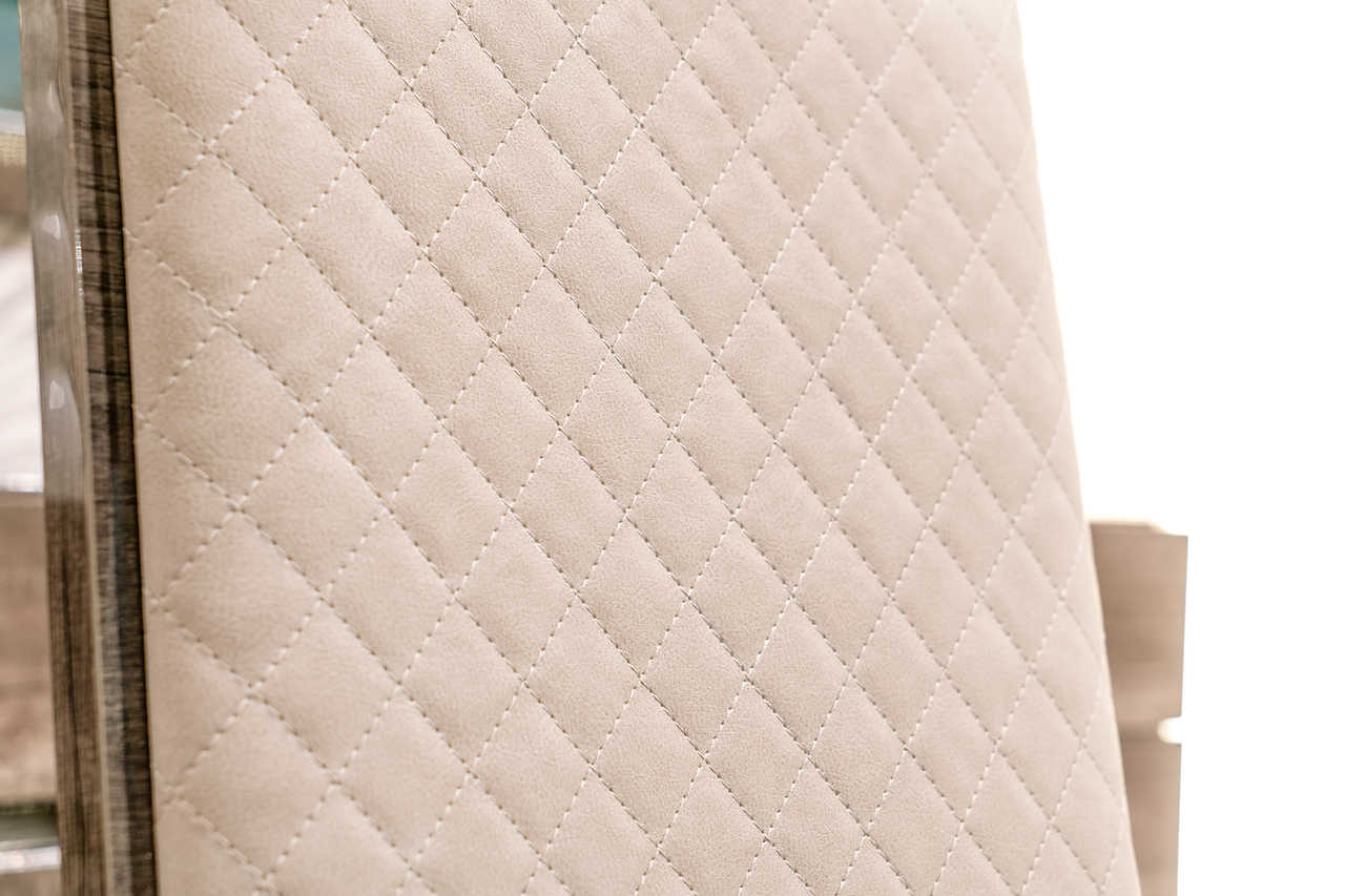Close-up of leather seat and chrome frame on Medea Dining Chair