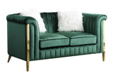 Close-up detail of emerald green velvet fabric and gold legs on Fara sofa