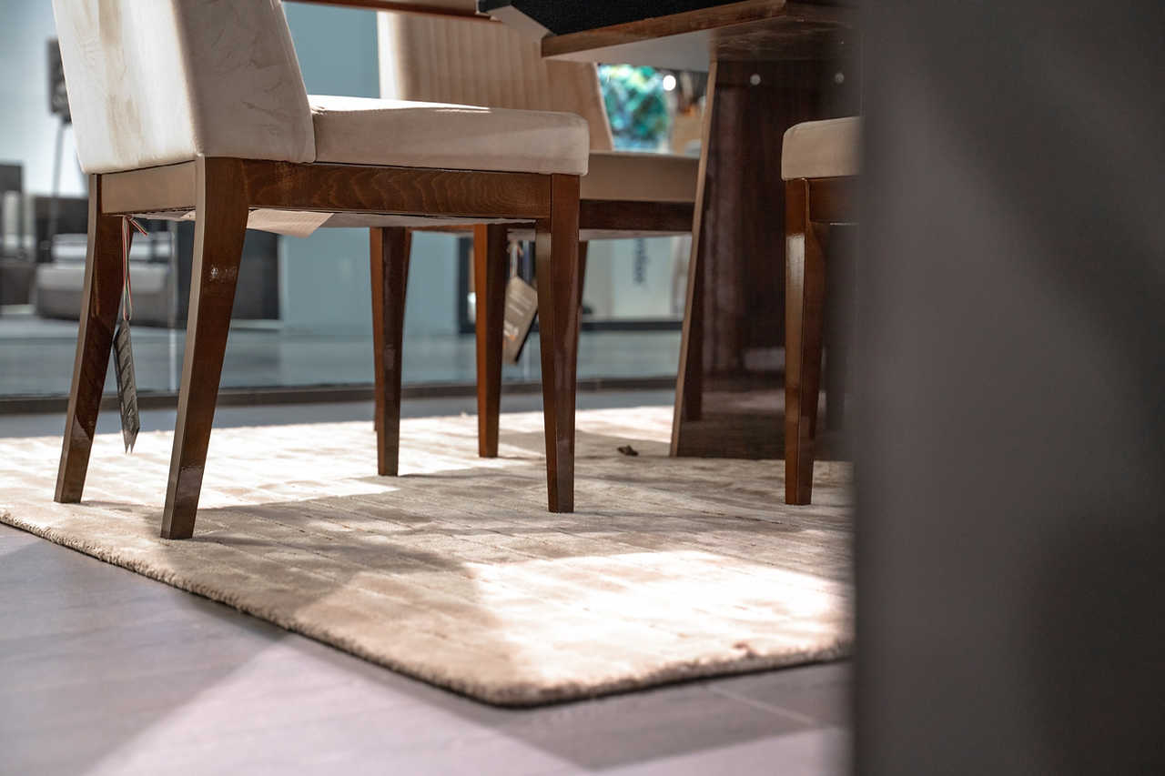 Eva Chair showcasing brass metal hardware and walnut finish