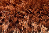 Angled view of Afro Shag Rust 5x7 Art Silk Shine Rug