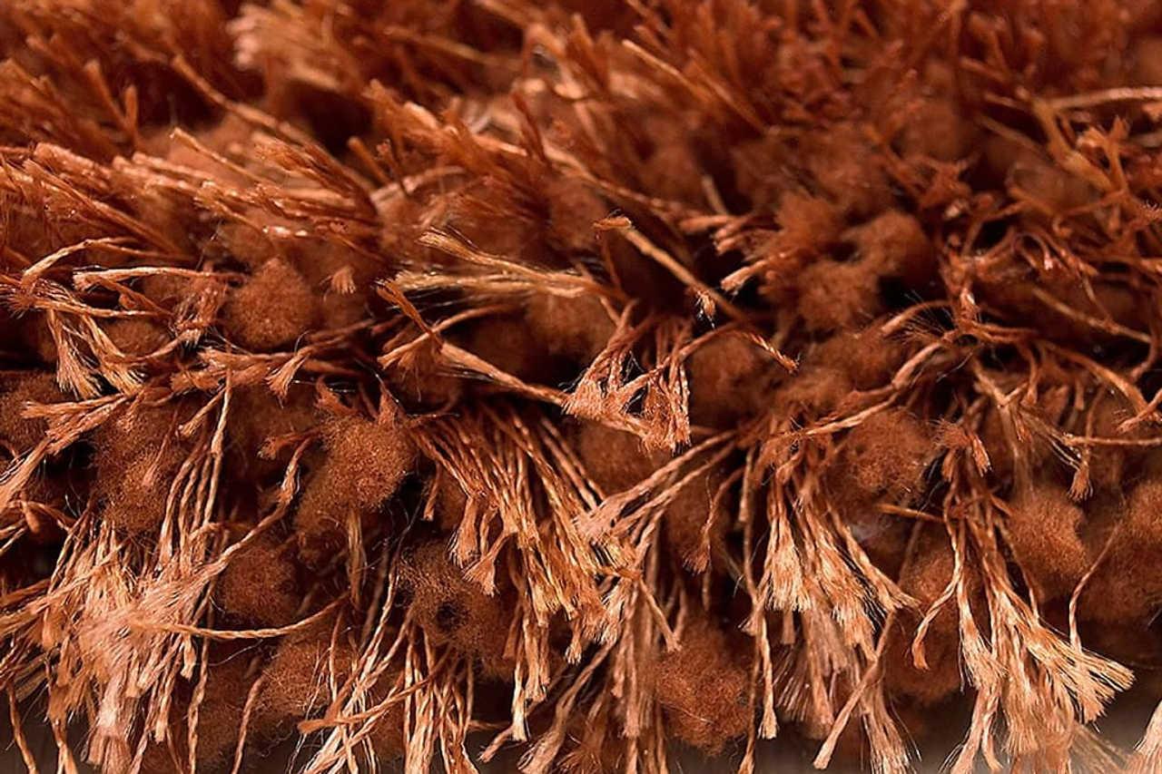 Angled view of Afro Shag Rust 5x7 Art Silk Shine Rug
