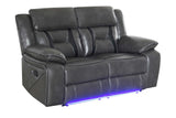 Drop-down table on reclining sofa in light grey