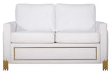 Close-up detail of white velvet upholstery and gold accents