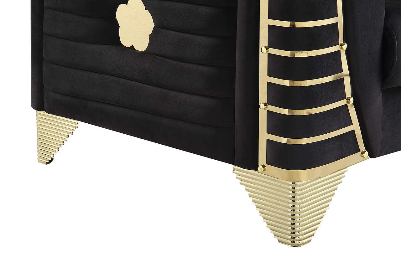 Close-up of black velvet upholstery and metal legs on Donovan set