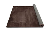 Detailed view of rug edge and fabric in chocolate brown