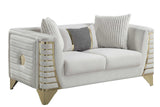 Close-up detail of cream velvet upholstery and gold accents