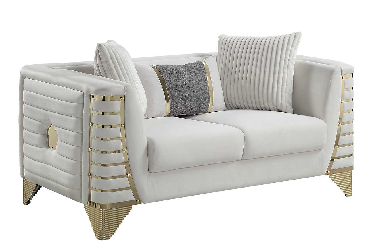 Close-up detail of cream velvet upholstery and gold accents