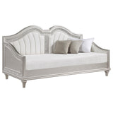 Close-up of ivory fabric upholstery and silver faux diamond trim