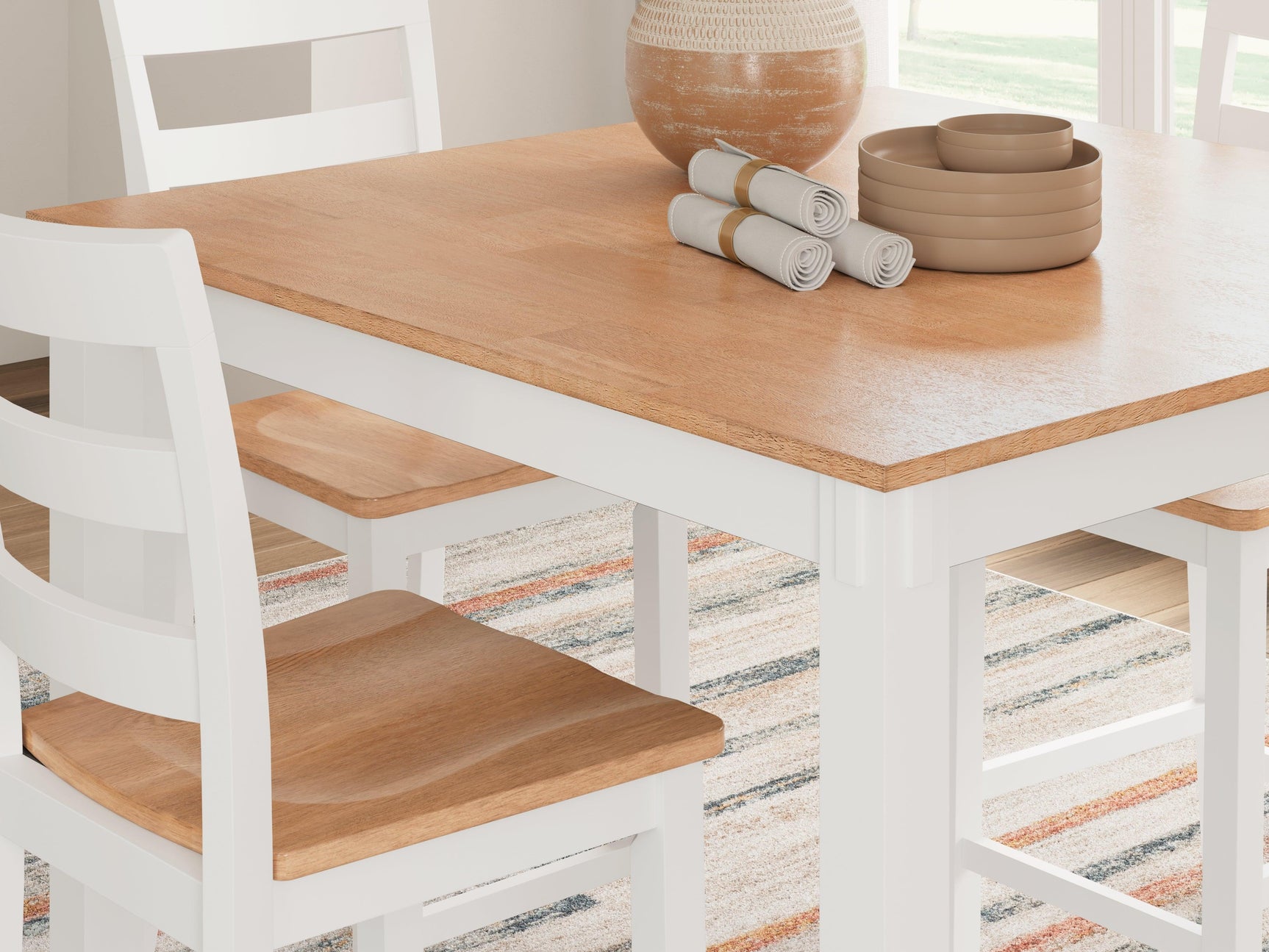 Barstools tucked under Gesthaven counter height table