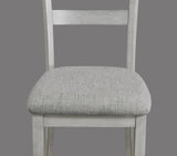 Side view of Henderson driftwood dining table with four upholstered chairs