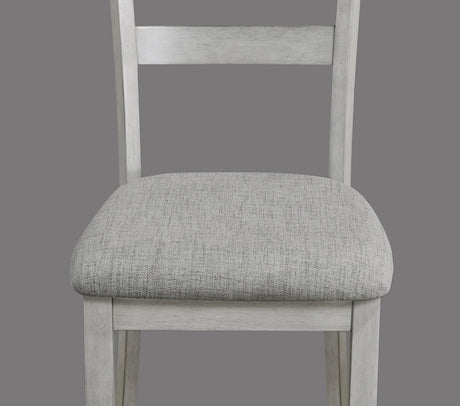 Side view of Henderson driftwood dining table with four upholstered chairs