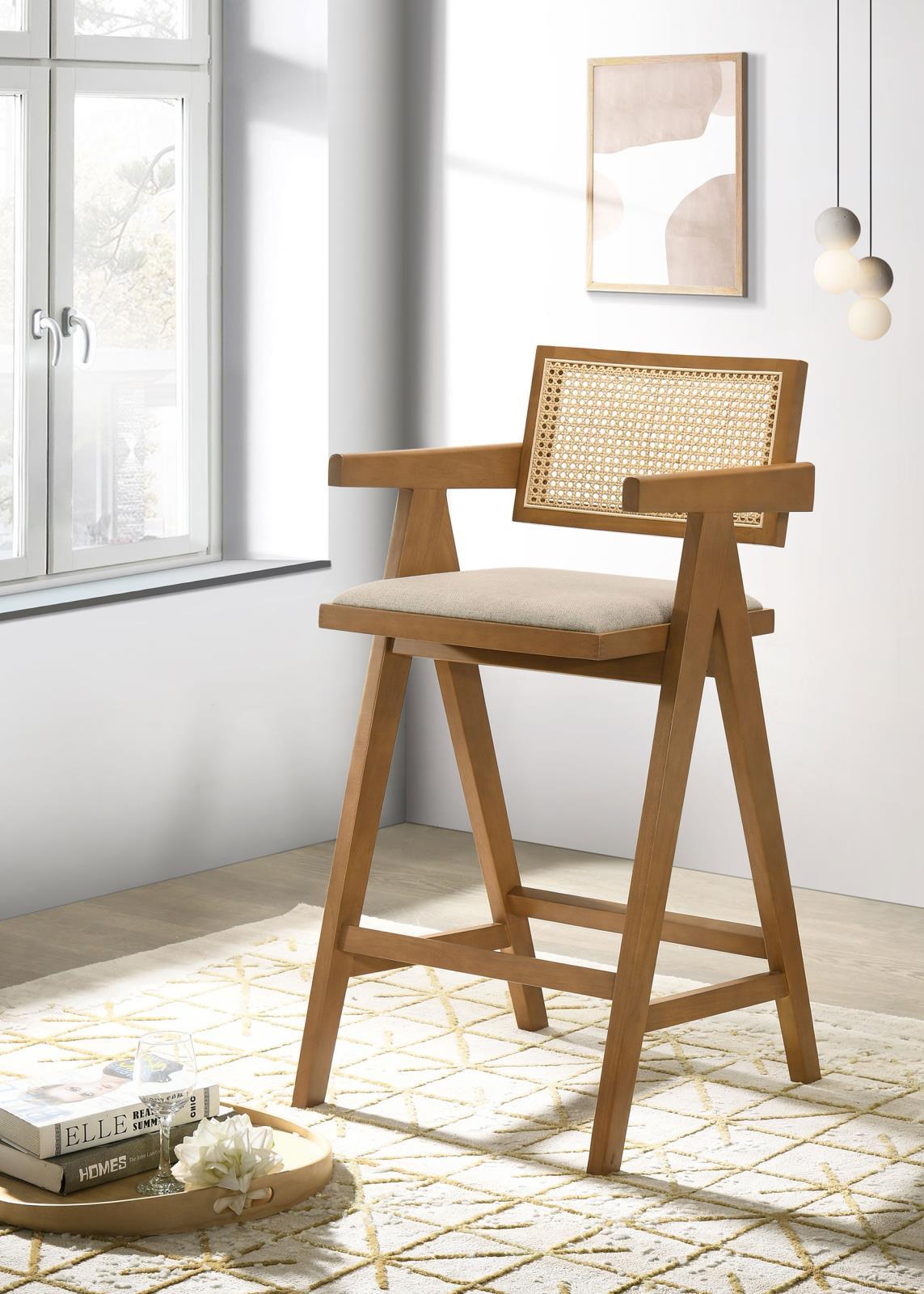 Side angle of Kane light walnut bar stool with rattan back and upholstered sand seat