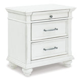 Side perspective of Kanwyn Whitewash Panel Storage Bedroom Set bed