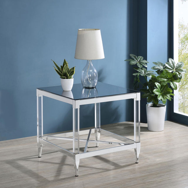 Side angle of Lindley Square End Table highlighting chrome metal frame and clear acrylic legs